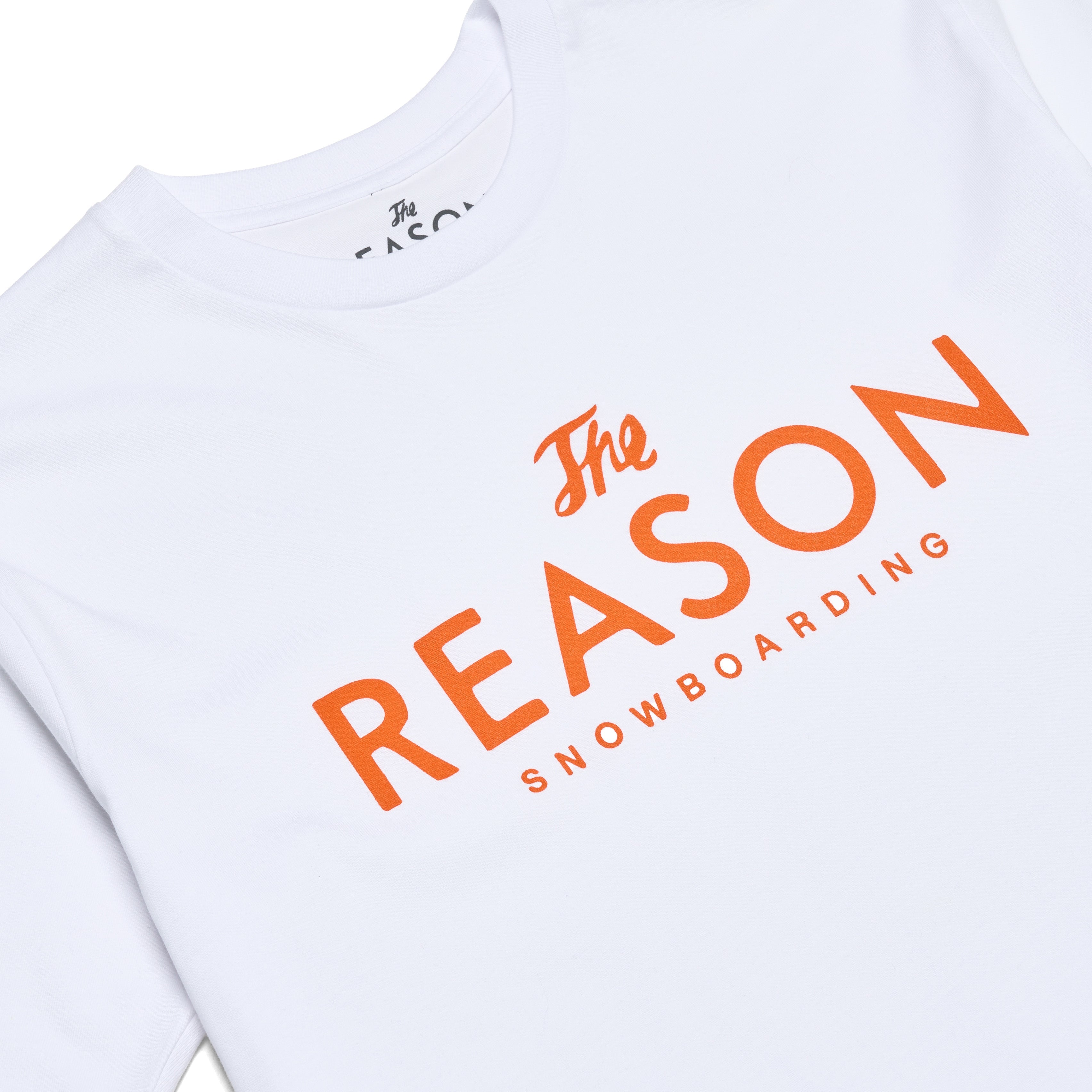 White t-shirt with orange text 'The Reason Snowboarding' on a white background