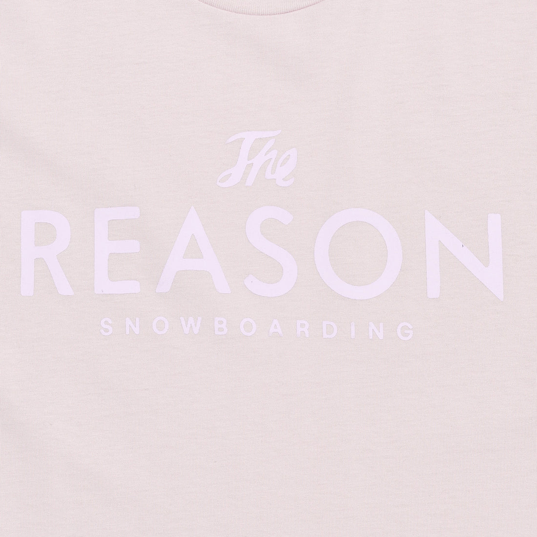 Light pinkt-shirt with 'The Reason Snowboarding' text on a light pink background