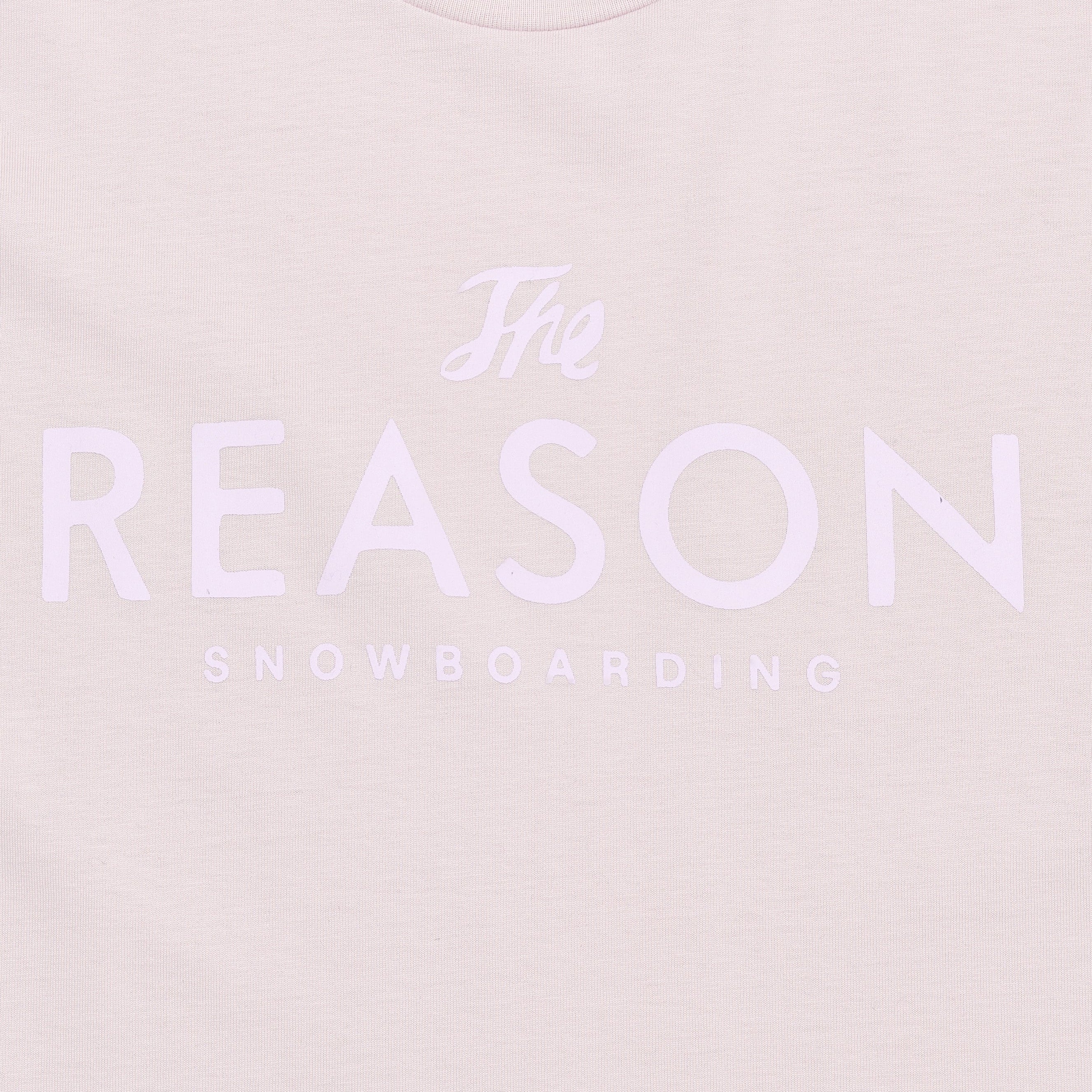 Light pinkt-shirt with 'The Reason Snowboarding' text on a light pink background