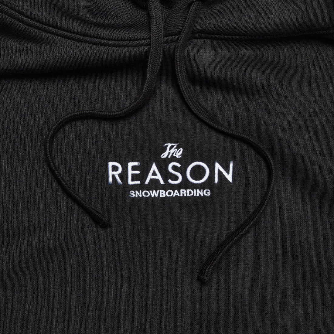 Black hoodie with 'The Reason Snowboarding' logo on a dark background